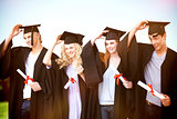 Composite image of group of teenagers celebrating after graduation