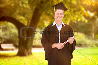 Composite image of man smiling as he has just graduated with his degree