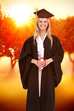Composite image of smiling blonde student in graduate robe