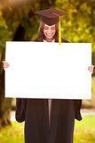 Composite image of a smiling woman as she holds and looks at a blank sheet in front of her