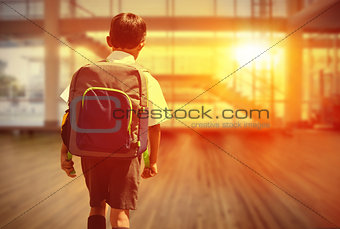 Composite image of cute pupil walking to the school bus