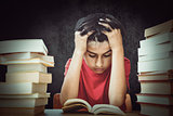 Composite image of tensed boy sitting with stack of books
