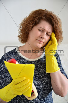 woman with a headache after cleaning the house