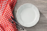 Plate and Cutlery on a Table with Tablecloth