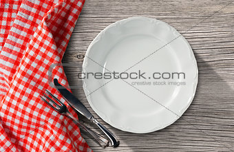 Plate and Cutlery on a Table with Tablecloth