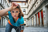 Young woman in sportswear is catching breath