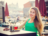 Young Woman Drinking Tea in a Cafe Outdoors.