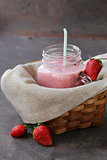 strawberry smoothie with fresh berries and yogurt in a glass jar