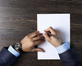 Male hands with pen over document
