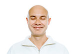 Bald smiling man with his eyes closed. Isolated. Studio