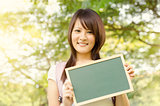 Young Asian college girl student with blank chalkboard