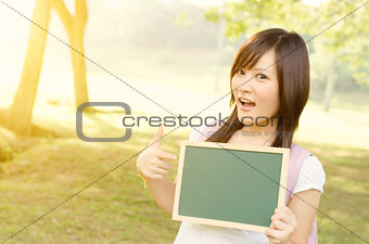 Asian female college student with blank chalkboard