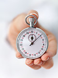 The clock is ticking - stopwatch in woman hand