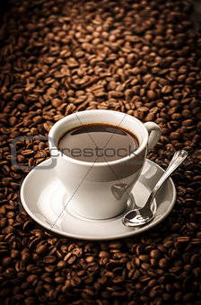 Black coffee on beans background