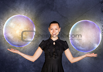 Businesswoman holding two big bubbles