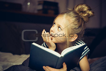 Girl reading a book and dreams