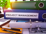 Project Management on Blue Office Folder. Toned Image.