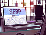 SERP on Laptop in Modern Workplace Background.