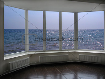 big office windows with view of marine waves