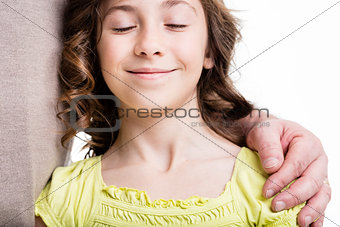 serene girl with his father's hand on her shoulder