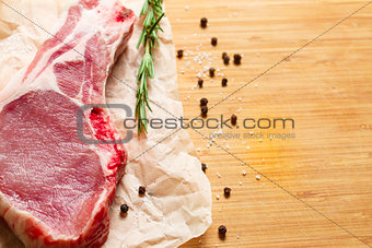 Pieces of crude meat with rosemary and spices