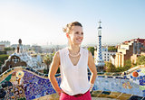 Happy woman tourist in Park Guell, Spain looking into distance