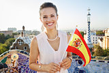 Woman tourist with Spain flag in Park Guell, Barcelona, Spain