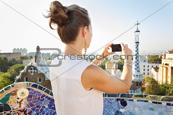 Seen from behind woman taking photo in Park Guell, Barcelona
