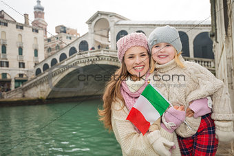 Mother and daughter with Italian flag in front of Rialto Bridge