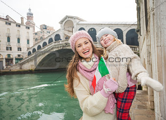 Mother and daughter with Italian flag near Ponte di Rialto