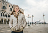 Woman tourist standing on St. Mark's Square near Dogi Palace