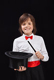Happy magician boy on black background