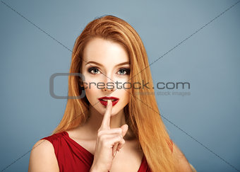 Hush. Sexy Woman with Finger on her Lips.
