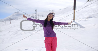 Happy young woman embracing the winter sun