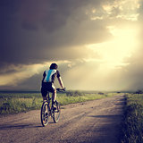 Epic Photo of Cyclist on Dramatic Sky Background