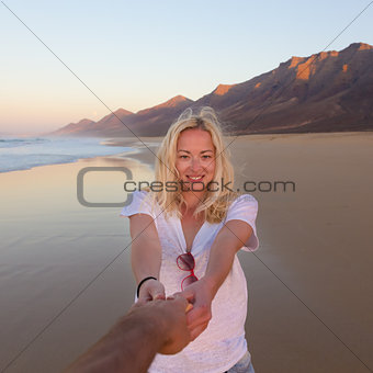 Romantic couple, holding hands,  on beach.