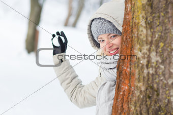 Girl snowball fighting in winter time.