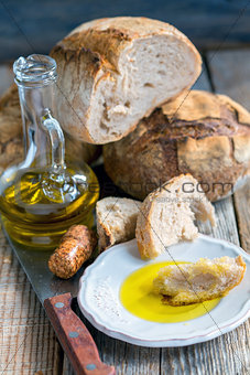 Plate with olive oil and homemade bread.