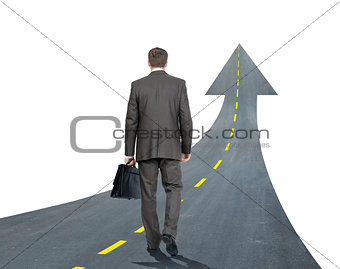 Businessman walking road going up llike arrow