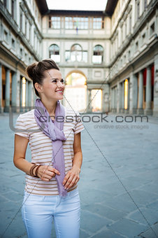 Happy woman tourist enjoying attractions of Florence, Italy