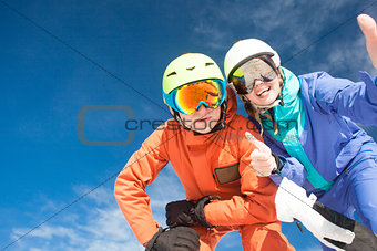 Picture of two snowboarders having fun on the top of Dolomiti Alps