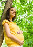 Beautiful pregnant woman in the park