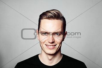 Portrait of young cheerful man looking at camera