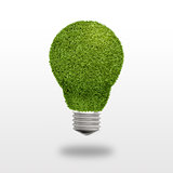 Light bulb with grass instead of glass on a white background