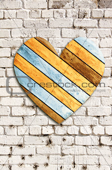 Wooden heart on old brick wall