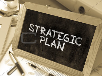 Strategic Plan Handwritten by white Chalk on a Blackboard.