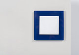light switch with blue glass frame on the wall