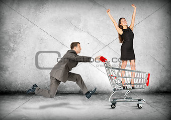 Businessman pushing shopping cart