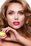 Close-up portrait of beautiful woman with bright make-up. Macarons.