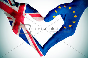 hands patterned with the British and the European flag forming a